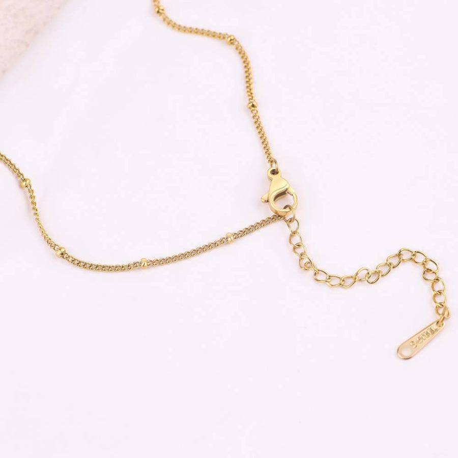 Initialhalsband med hjärta i pärlemor
