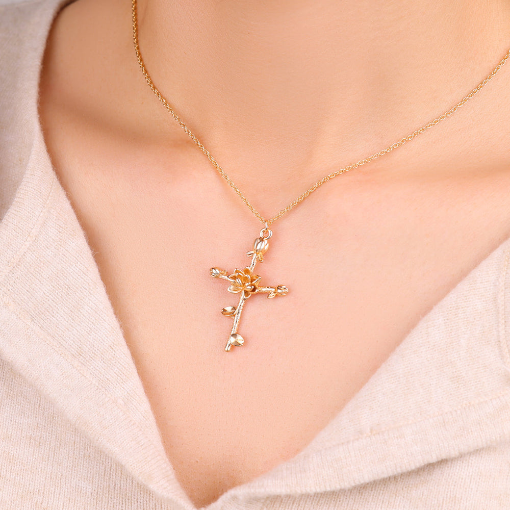 Halsband med blomsterkorshänge